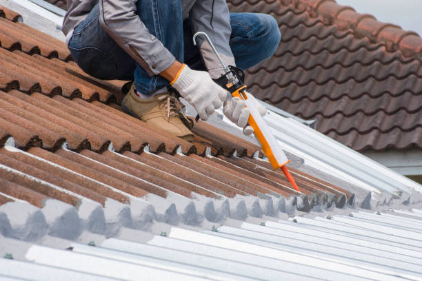 SwiftFix | Emergency Roof Repair in Birmingham Technician man hand using glue gun with silicone adhesive or manual caulking gun with polyurethane to seal the leak on the roof. Installing and building construction concept.