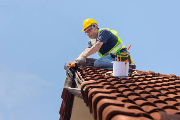 SwiftFix | Emergency Roof Repair in Birmingham Worker man repairing eaves and tile of the old roof.